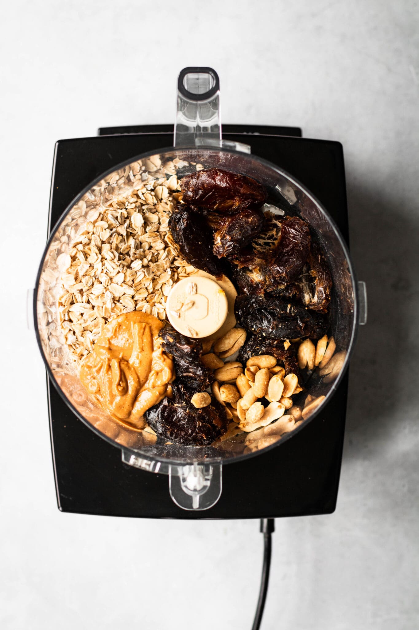 Cookie dough ingredients in a food processor, seen from the top.