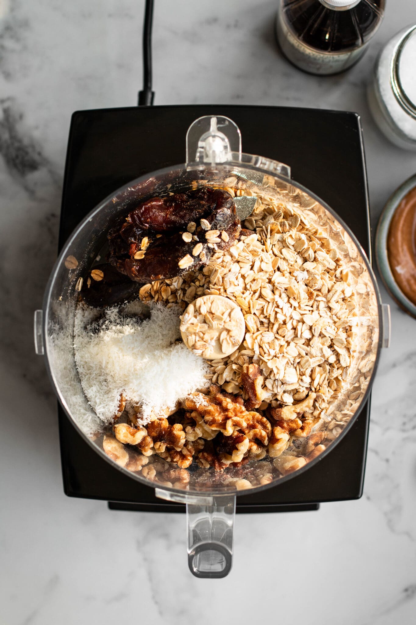 Cookie ingredients in a food processor, seen from the top.