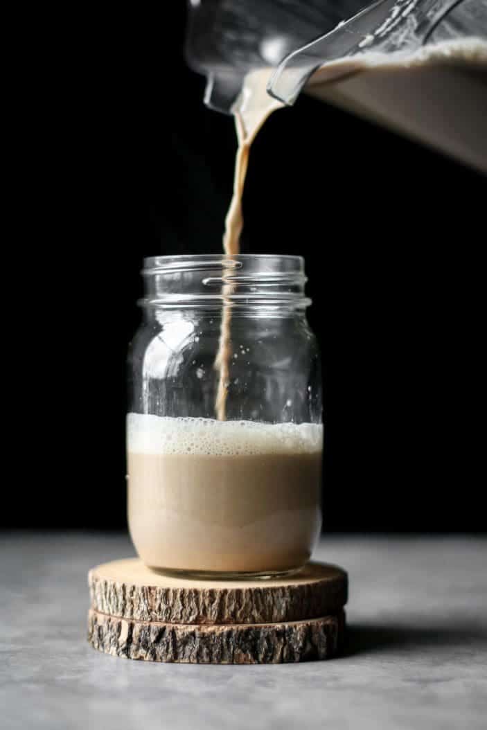 cashew dirty chai latte poured in a mason jar