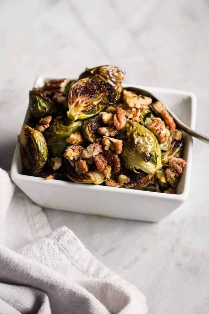 Roasted Brussels Sprouts with Garlic Pecans in a dish