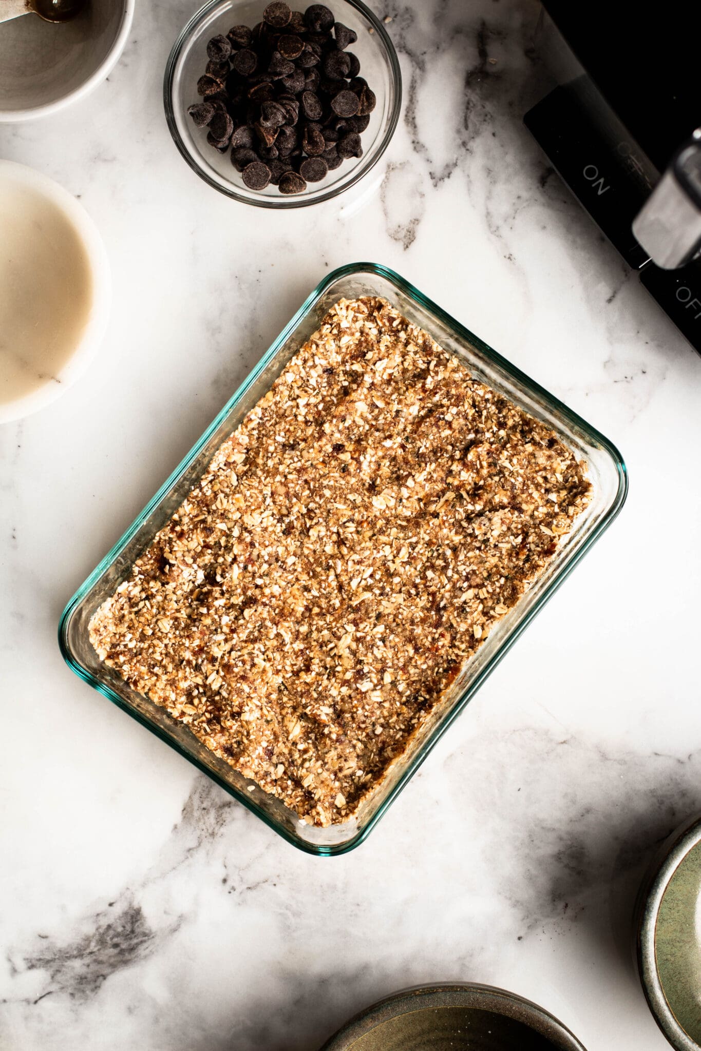 Granola bar mixture pressed in a glass container