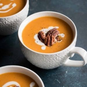 sweet potato soup served in cups and topped with pecans