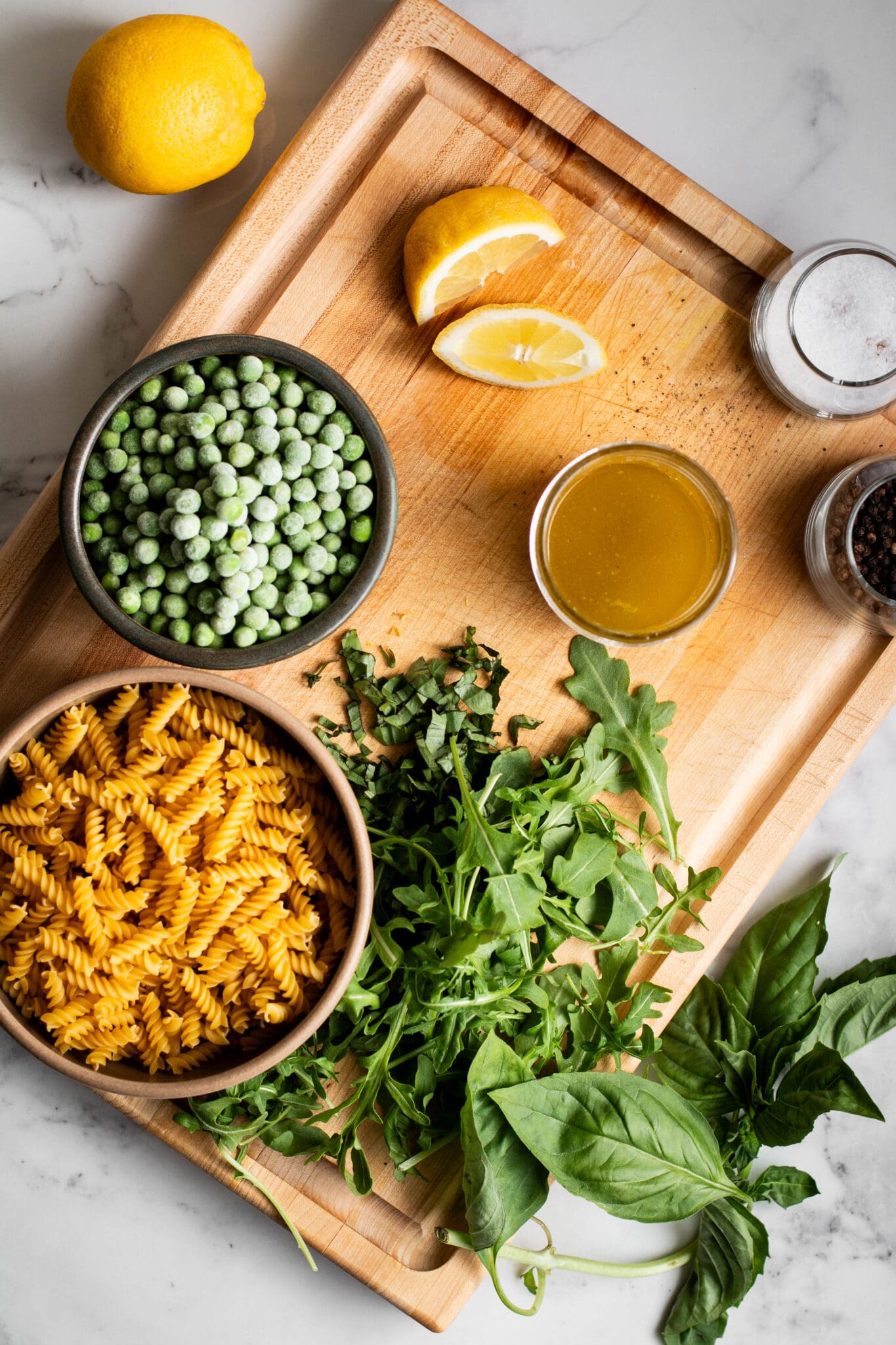 pasta salad ingredients on a cutting board.