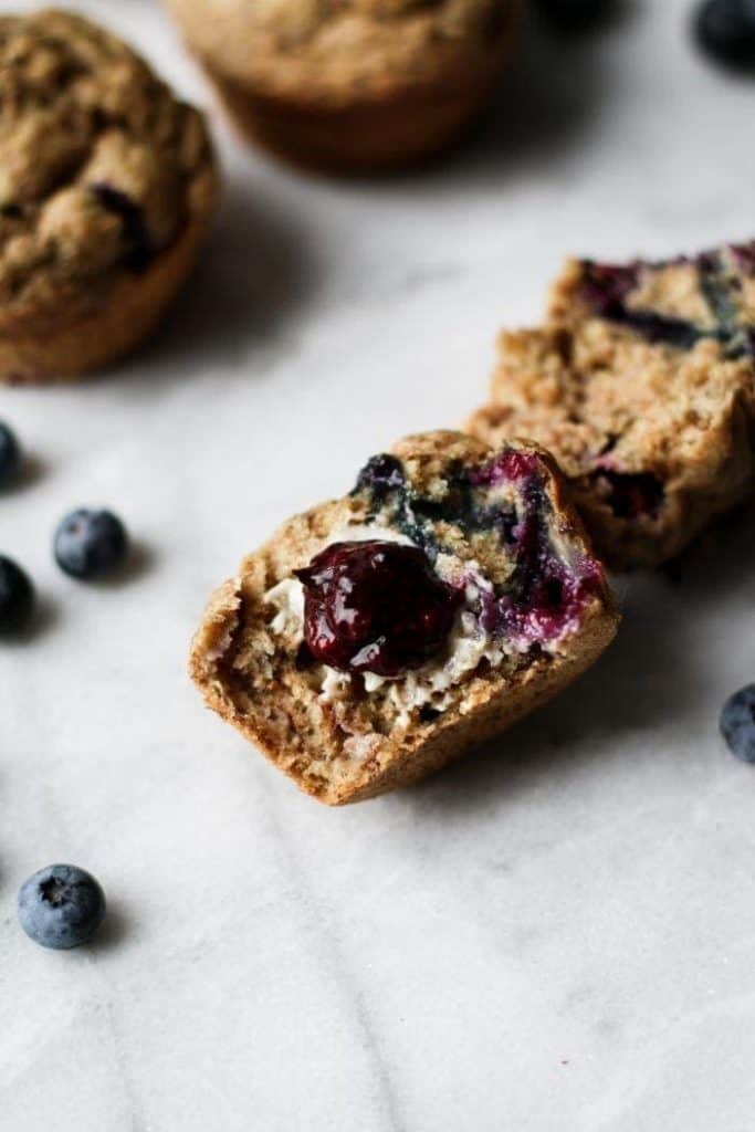 blueberry muffins cut in half with jam