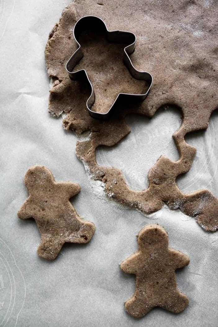 Chai-Spiced Cut-Out Cookies being made into gingerbread men seen from the top with the cut-out.