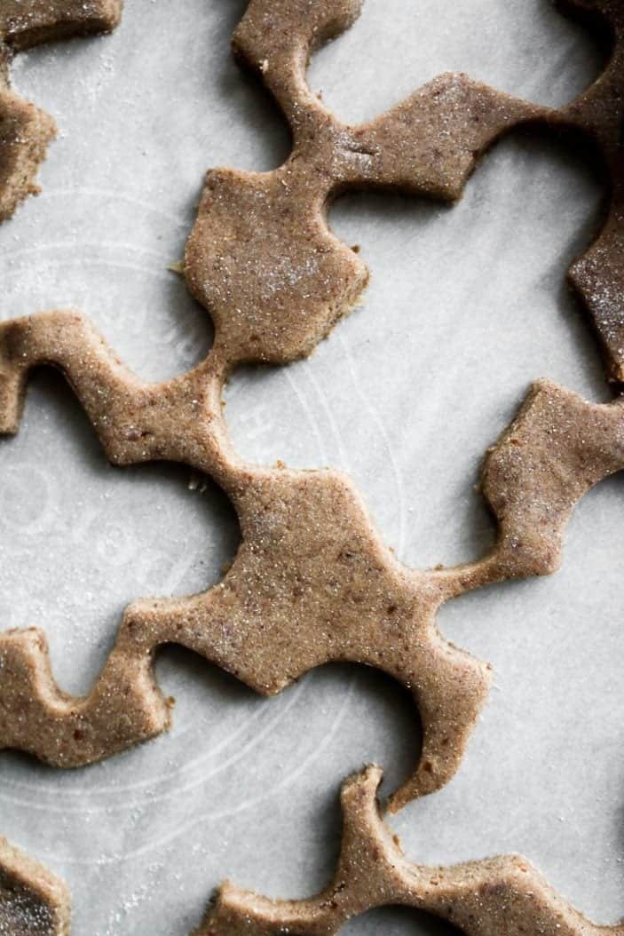 Chai-Spiced Cut-Out Cookies dough with gingerbread men removed from the dough.