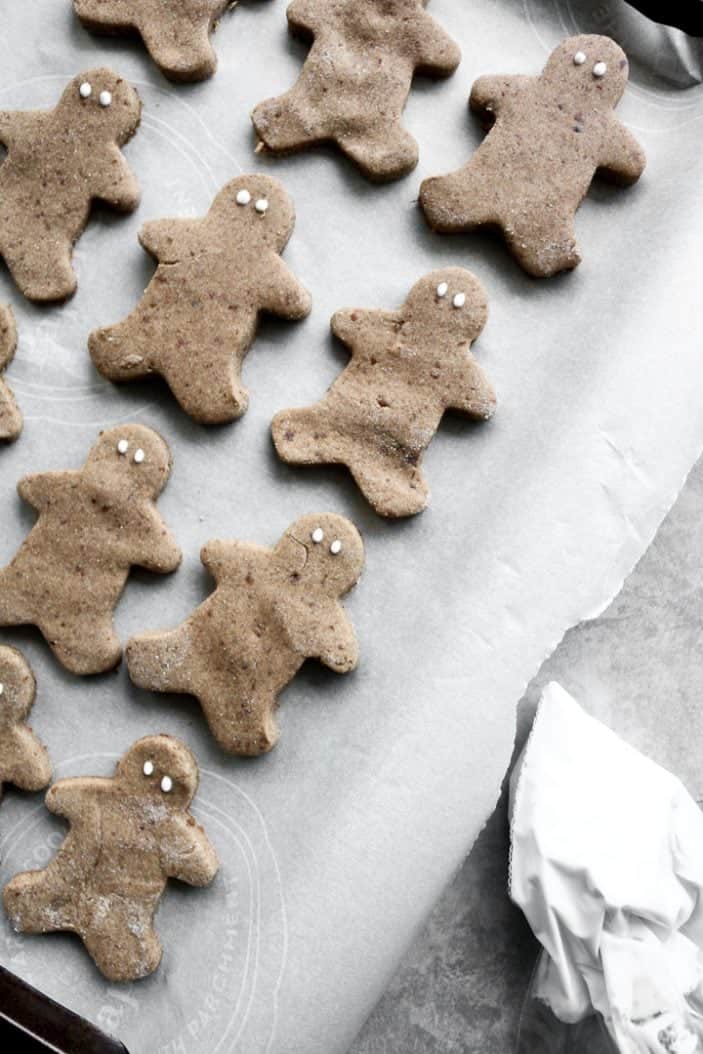 Chai-Spiced Cut-Out Cookies seen from the top as gingerbread men with little dots as eyes.