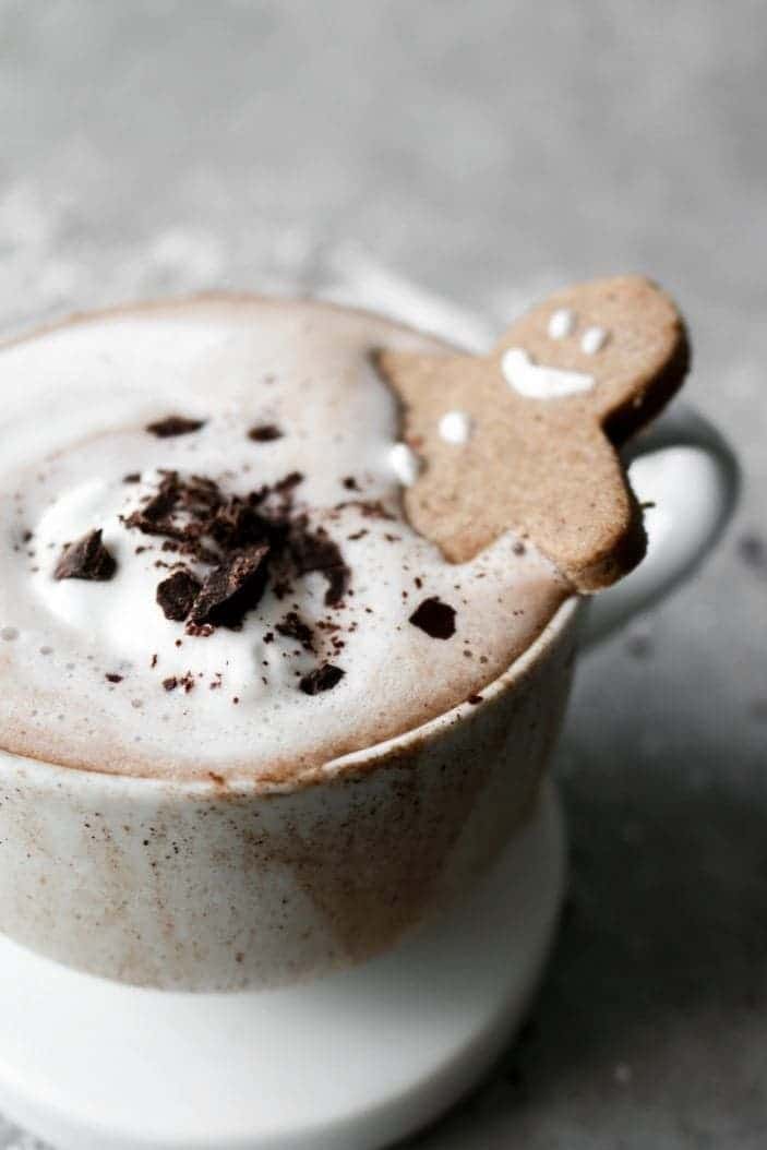 Creamy Sugar-Free Hot Chocolate seen from the side with a gingerbread man in the cup.