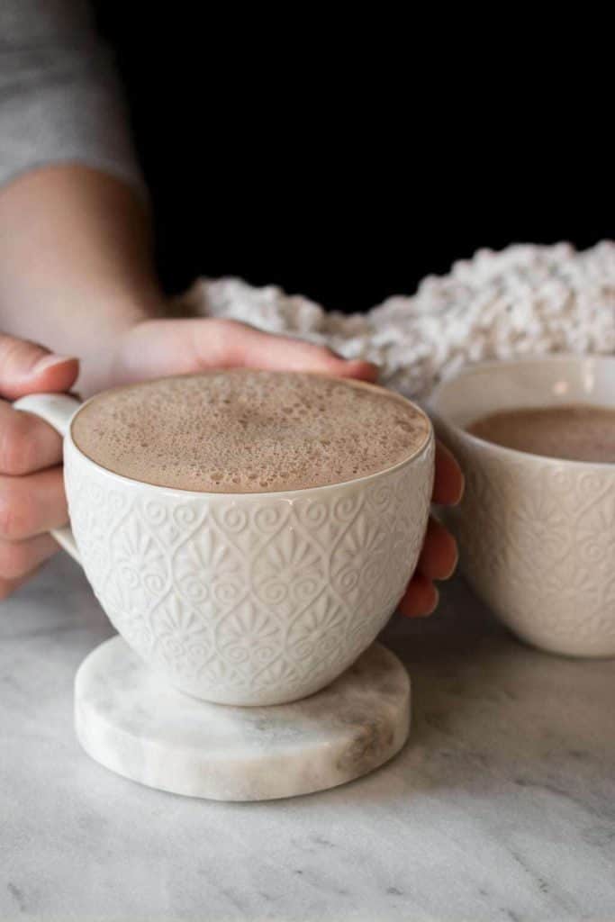hands holding cup of hot cocoa