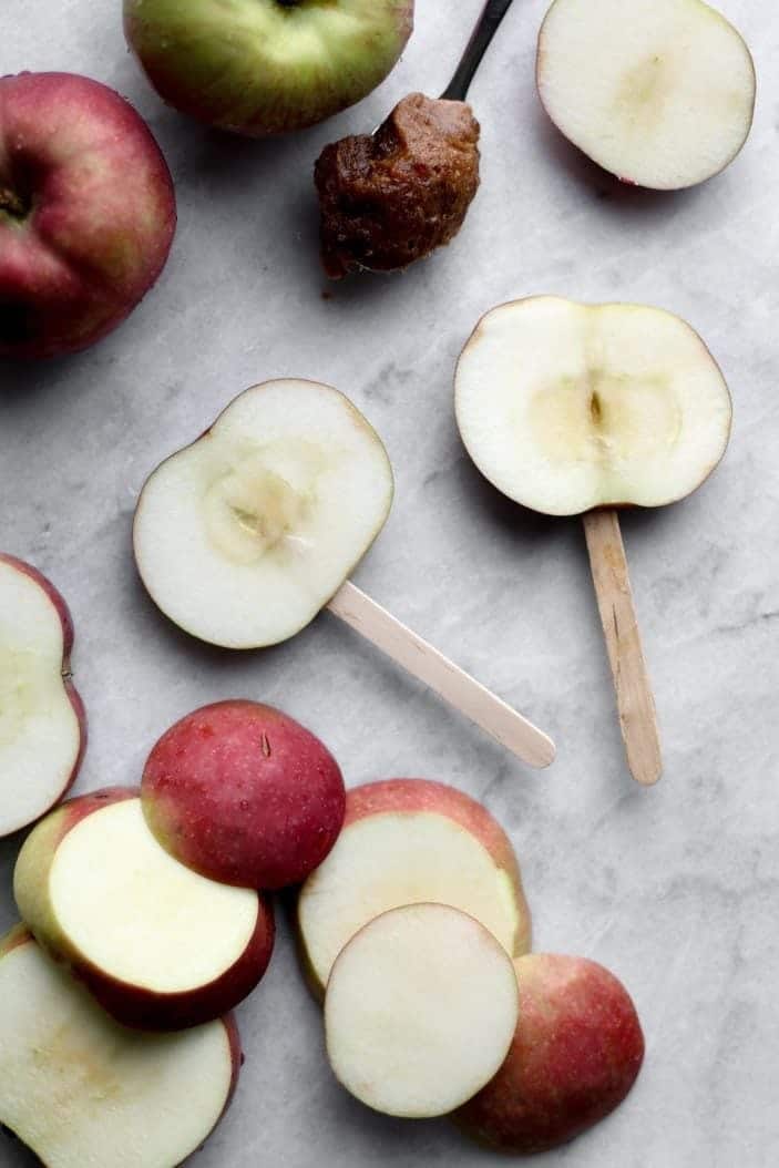sliced apples with popsicle sticks