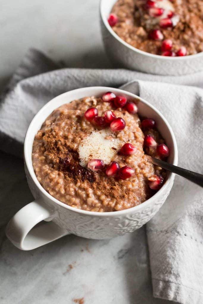 steel cut oats in a mug with pomegranate