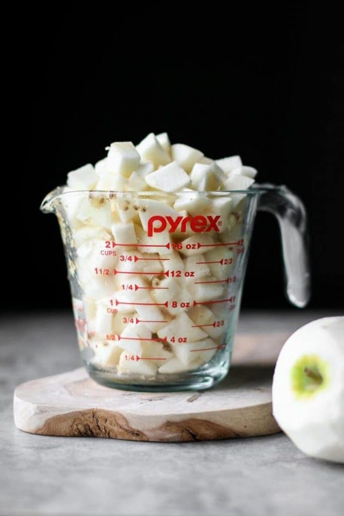 apples in a measuring cup from the side