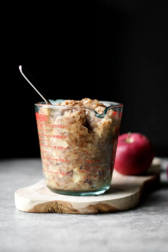 spiced chia applesauce in a measuring cup from the side