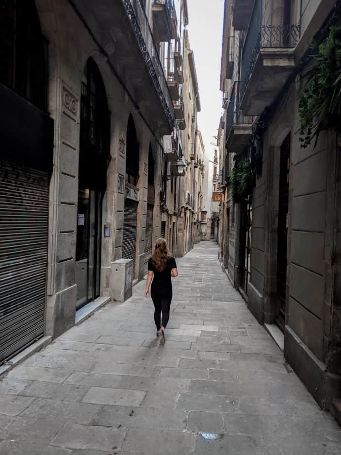 How to Stay Healthy While Traveling - girl walking in Barcelona 