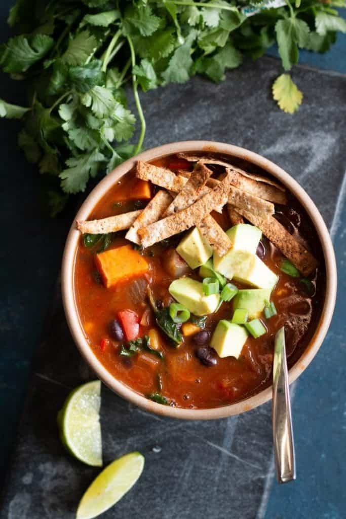 enchilada soup in bowl with cilantro