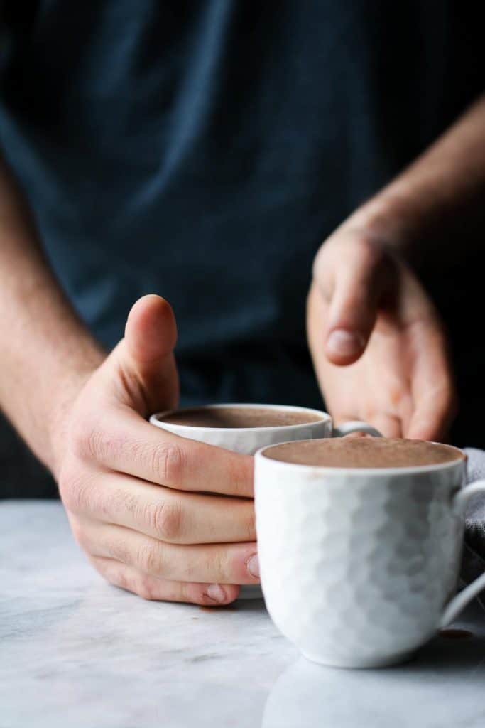 hands reaching for cup