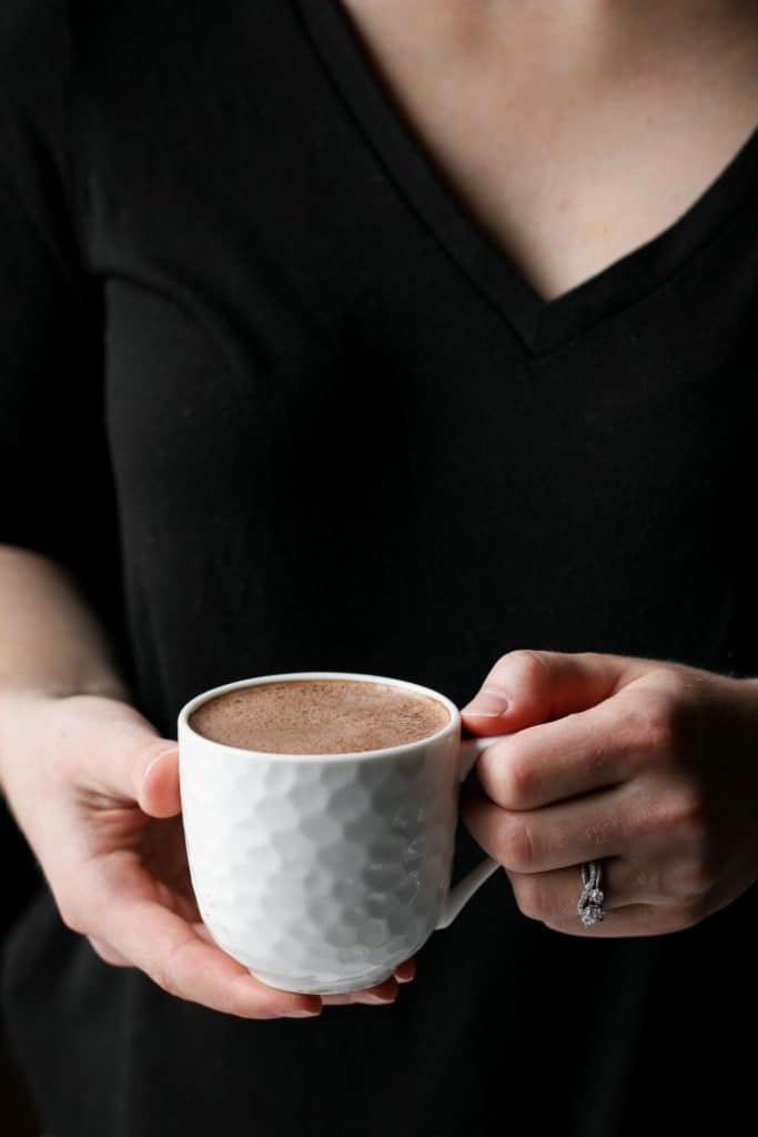 hands holding cup of peppermint mocha