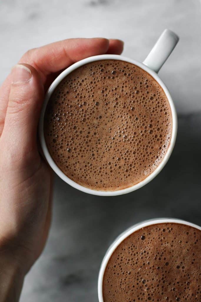 hand holding cup of peppermint mocha