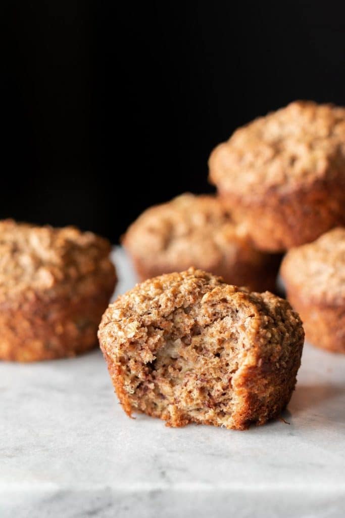 the healthiest banana bran muffin with bite taken from it