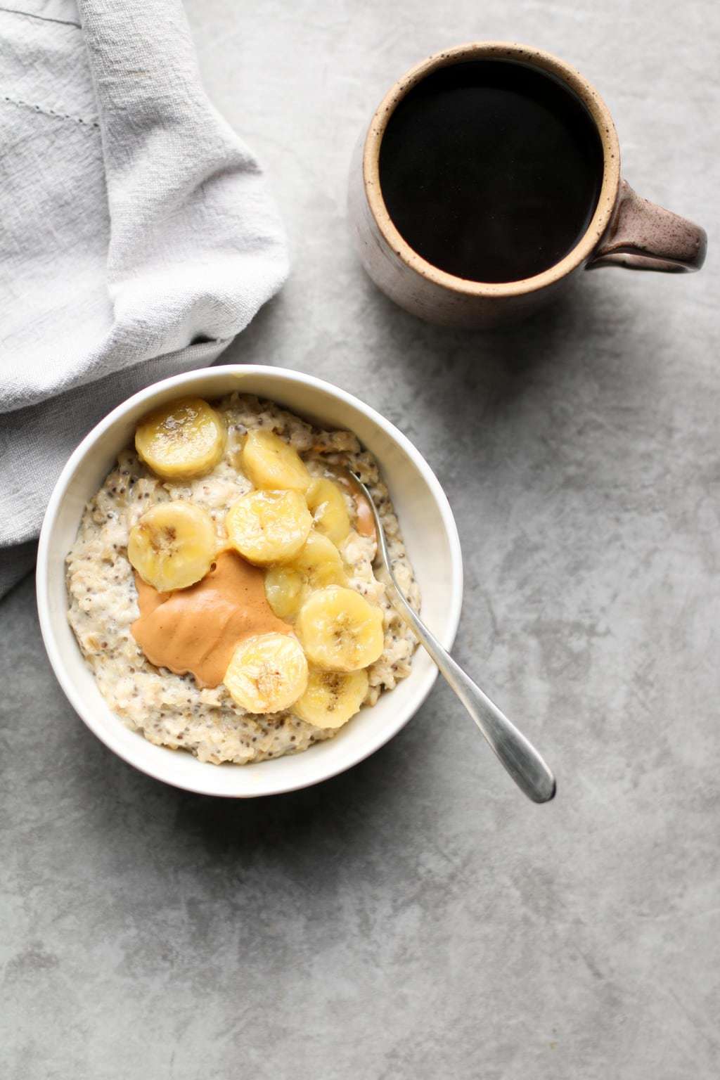 caramelized banana oatmeal in a bowl with coffee