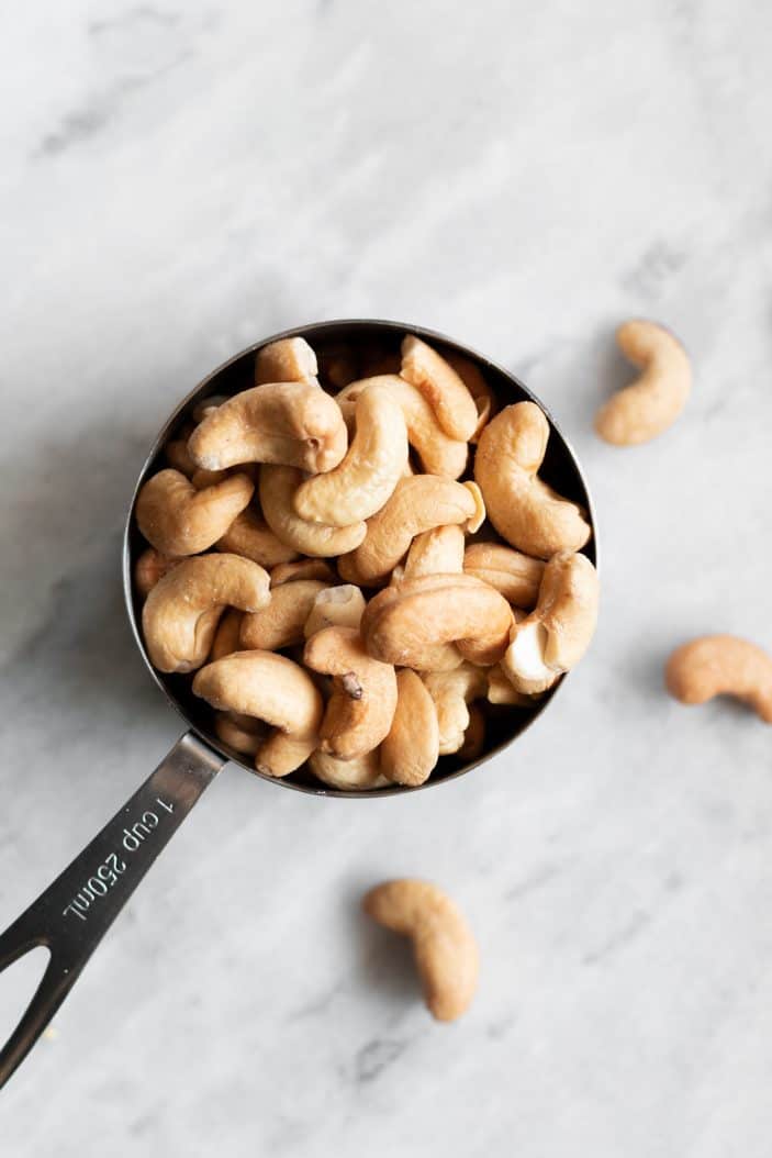 cashews in a measuring cup