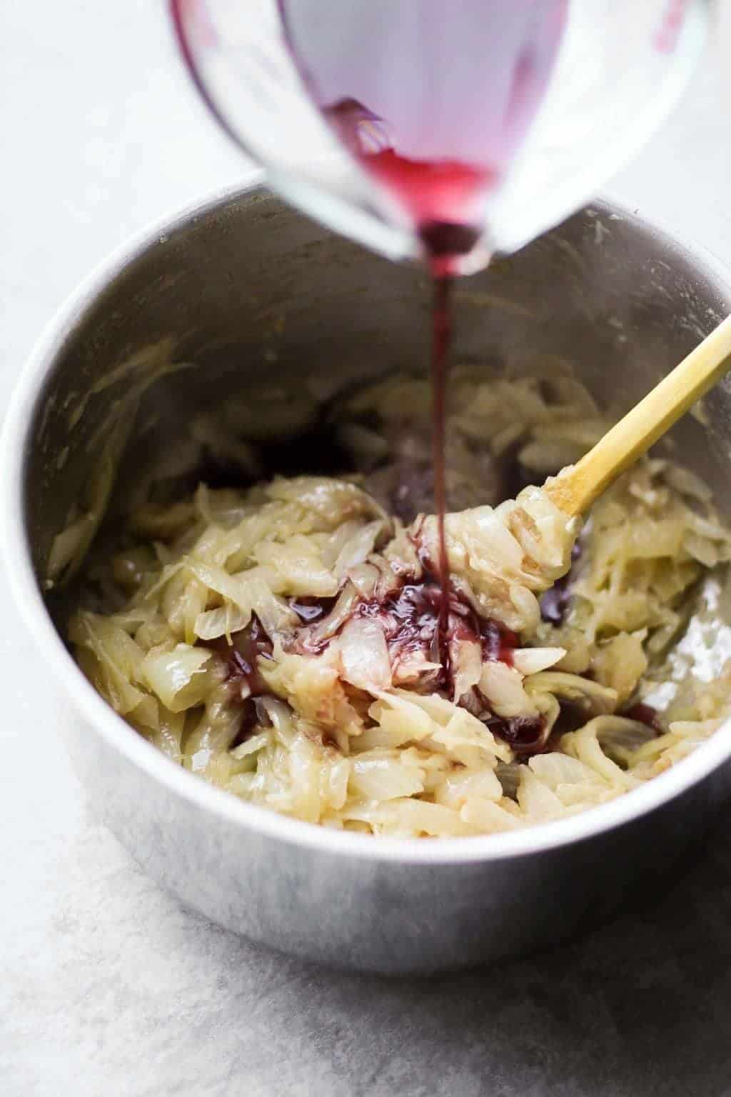 wine poured on caramelized onions