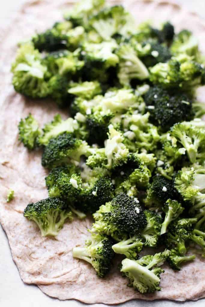 raw broccoli on crust