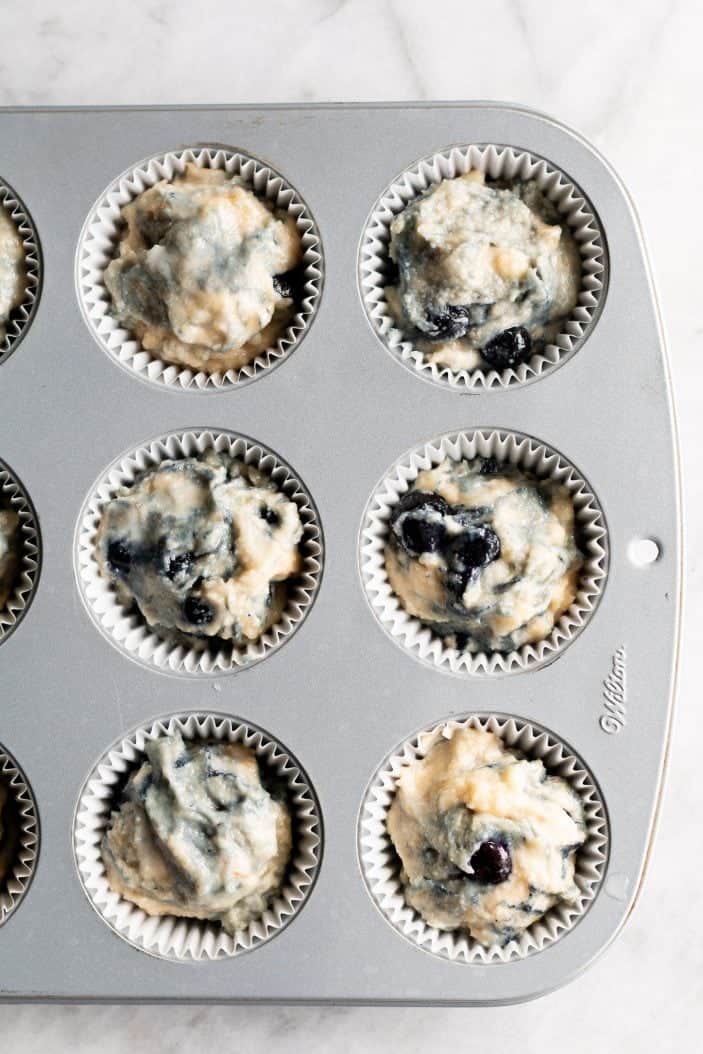 blueberry banana almond flour muffins in tins