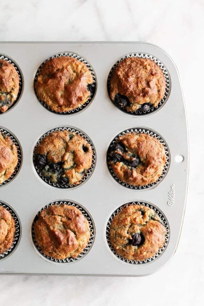 blueberry banana almond flour muffins baked in pan