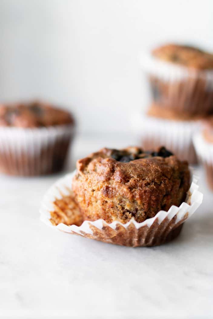 blueberry banana almond flour muffins in muffin liner