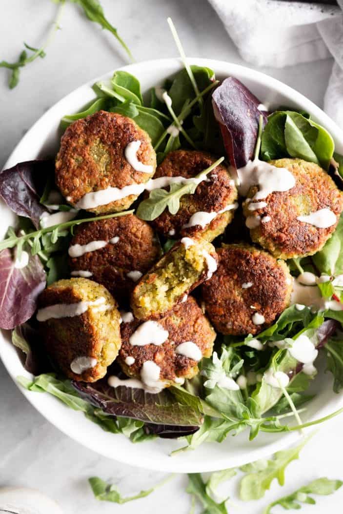 Basic Falafels with sauce in a bowl of greens
