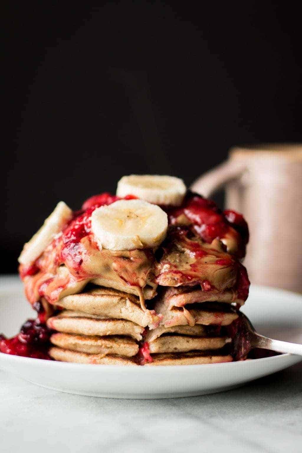 stack of banana Oatmeal Blender Pancakes with Berry Compote