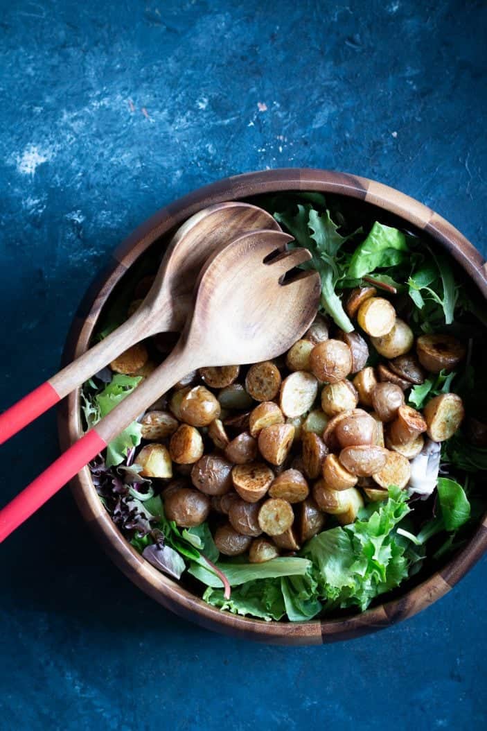 Roasted Potatoes and leafy greens in a bowl