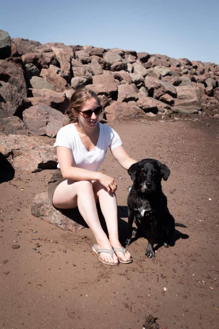girl and dog on a beach
