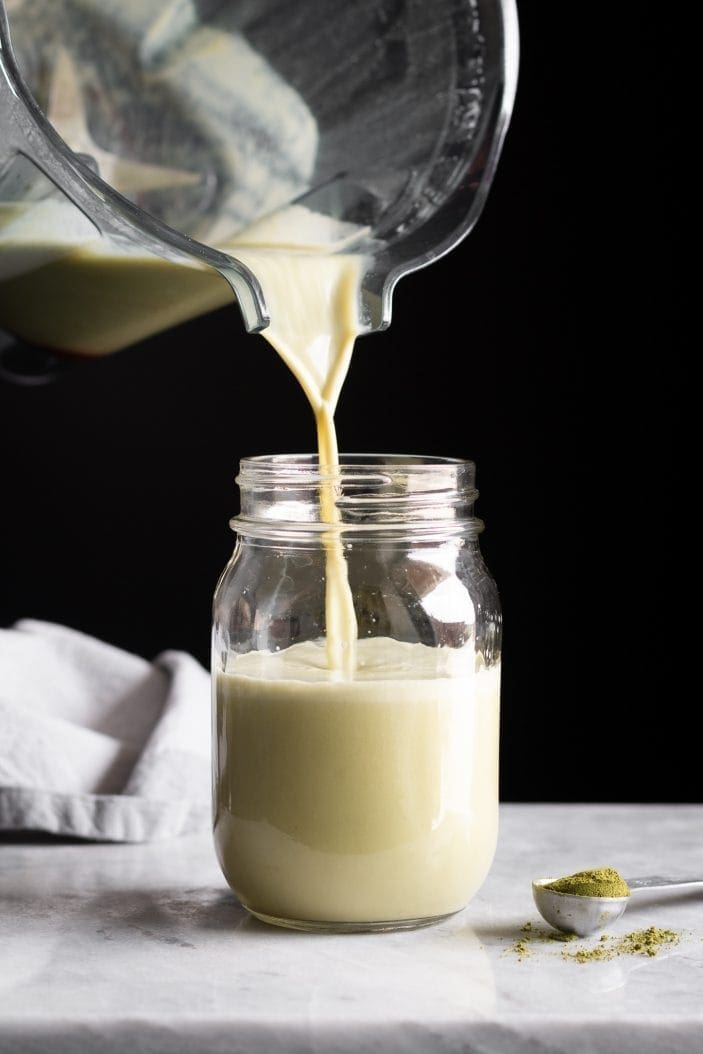 Iced Almond Matcha Latte poured in a jar