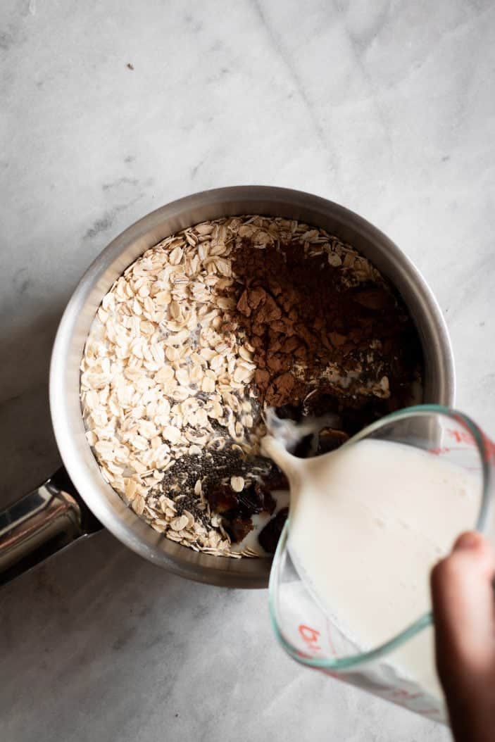 milk poured in saucepan with oatmeal