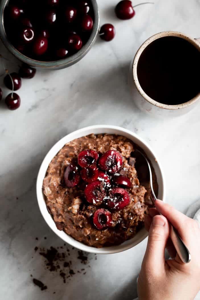 chocolate oatmeal in bowl with cherries