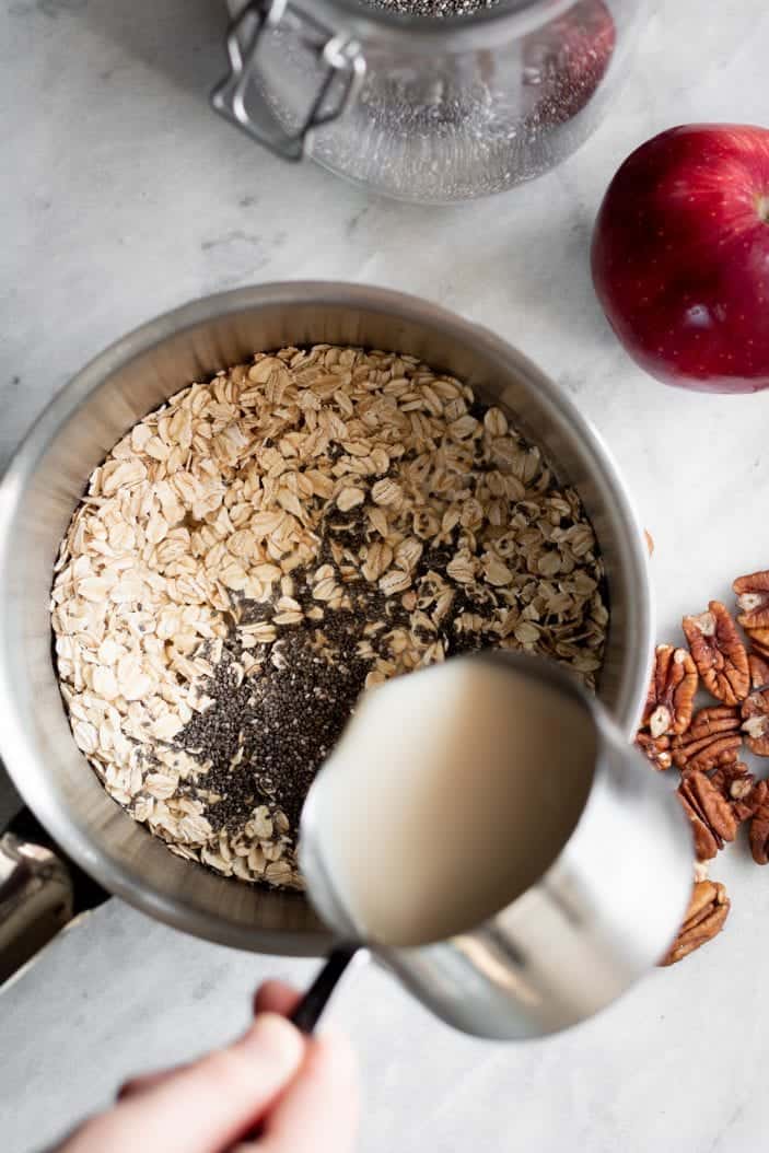 oats and chia in a saucepan with milk poured in