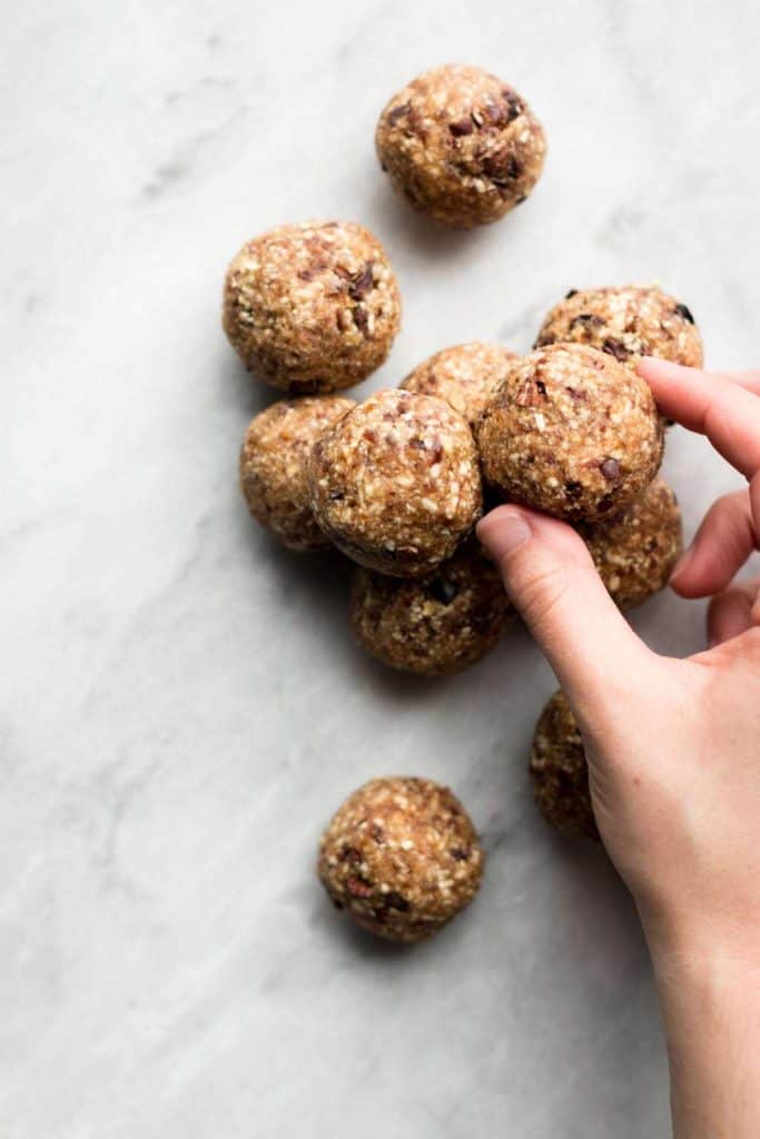 fingers holding cookie dough bites