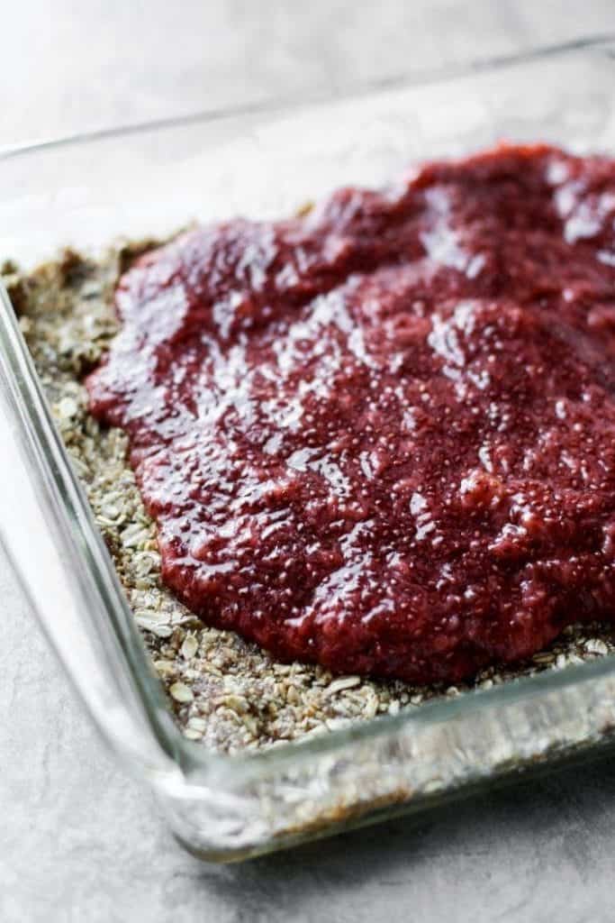 strawberry jam poured over crumble