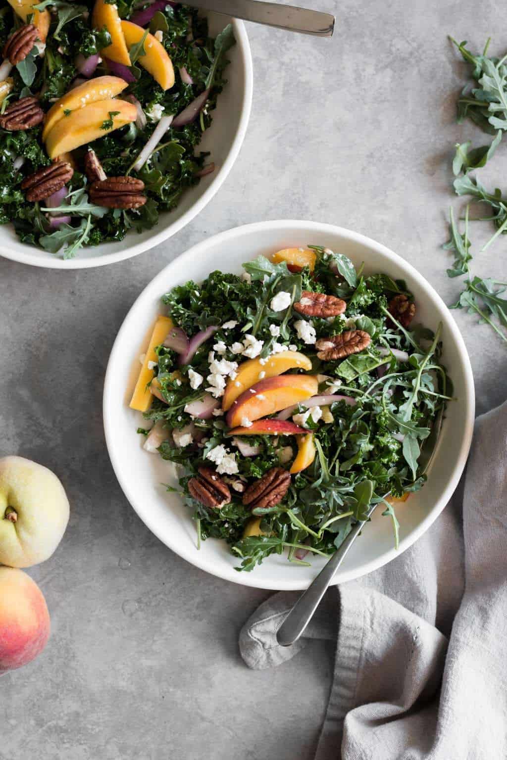 sweet peach kale salad in bowls