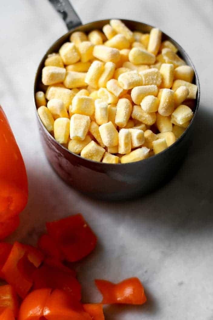 frozen corn in a measuring cup