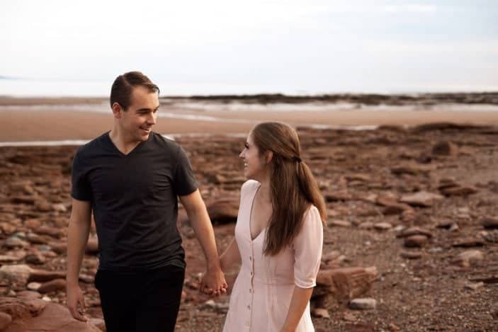 couple holding hands laughing - engagement photos