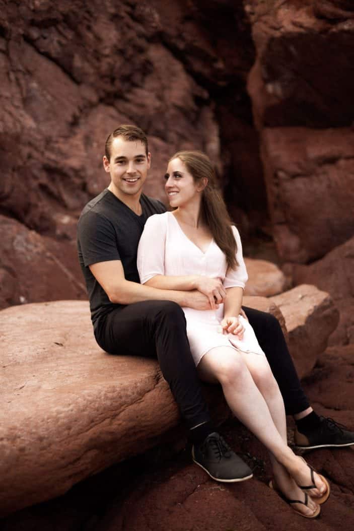 couple sitting on rock