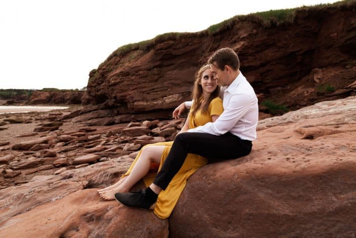 couple sitting on rock