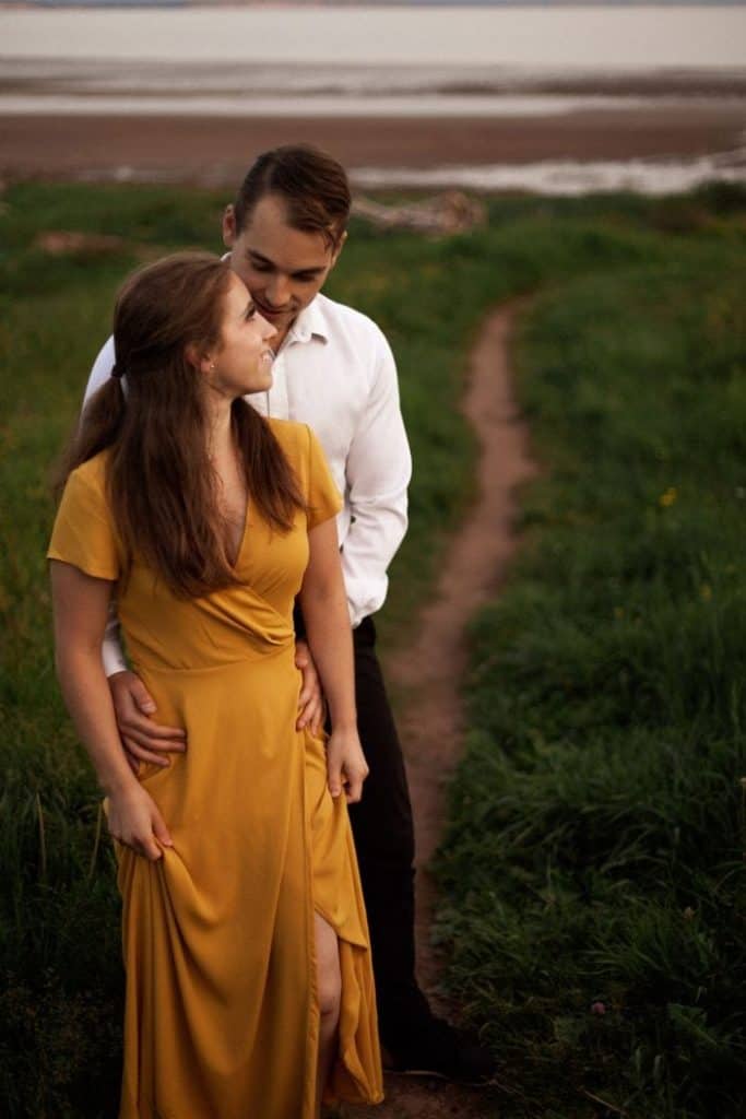 couple standing in the grass