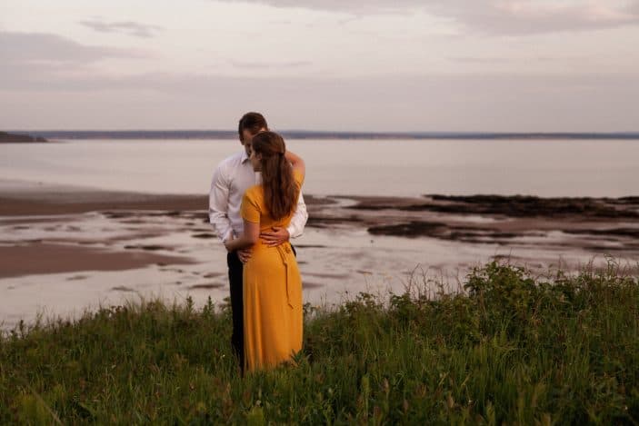 couple hugging in tall grass