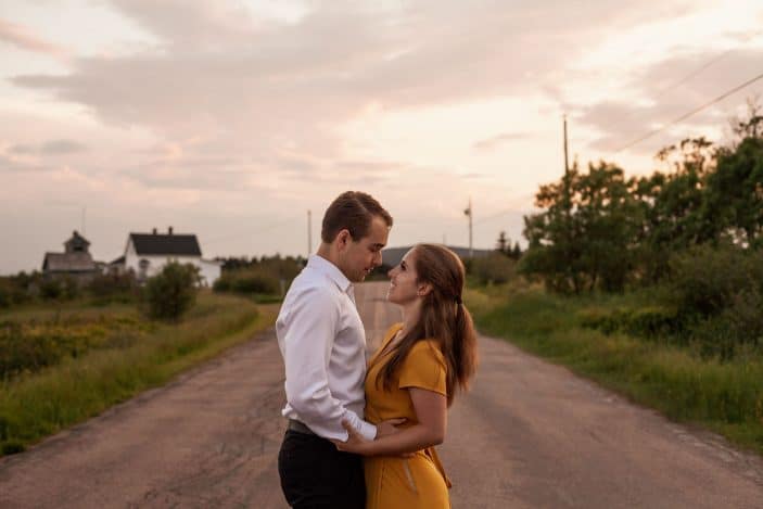 couple smiling in middle of the road