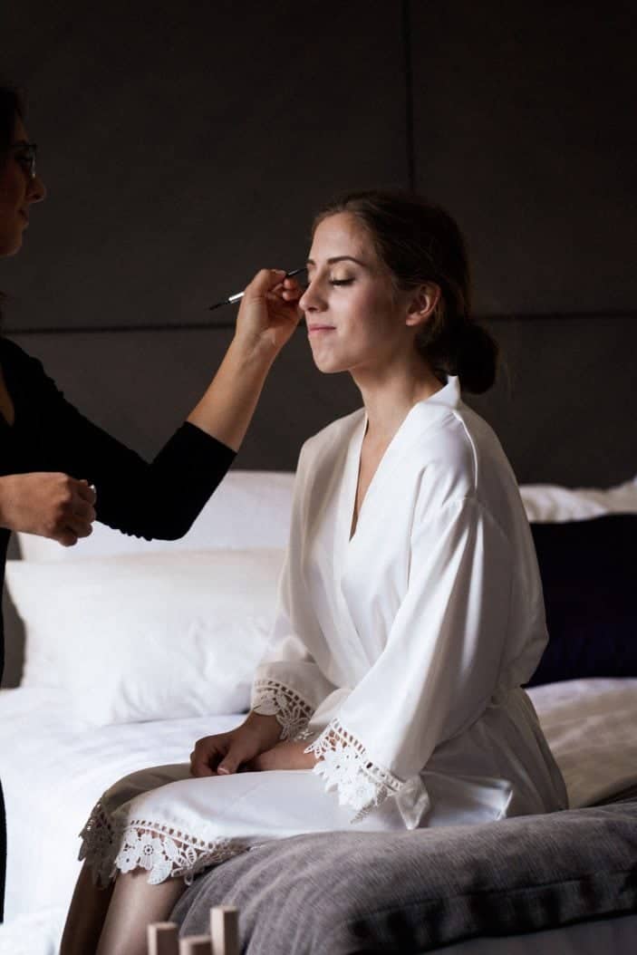 bride getting makeup done