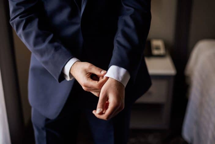 groom adjusting tux